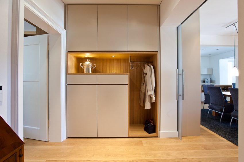 Built-in wardrobe with lighting in a small hallway