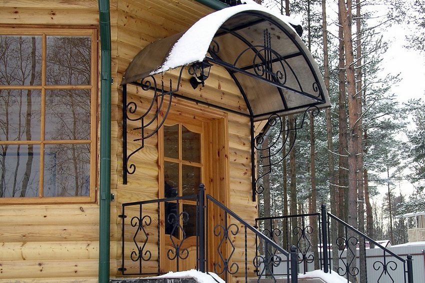 A visor over the porch will protect the entrance to the house from rain and snow