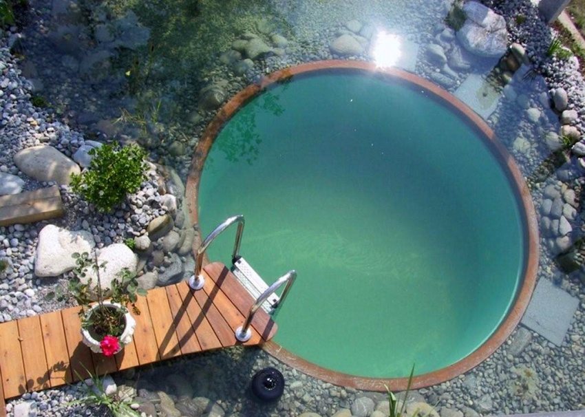 Round pool with a small wooden bridge
