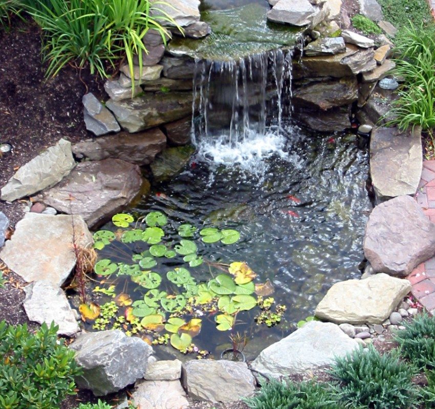 Small pond with a waterfall decorated with stones