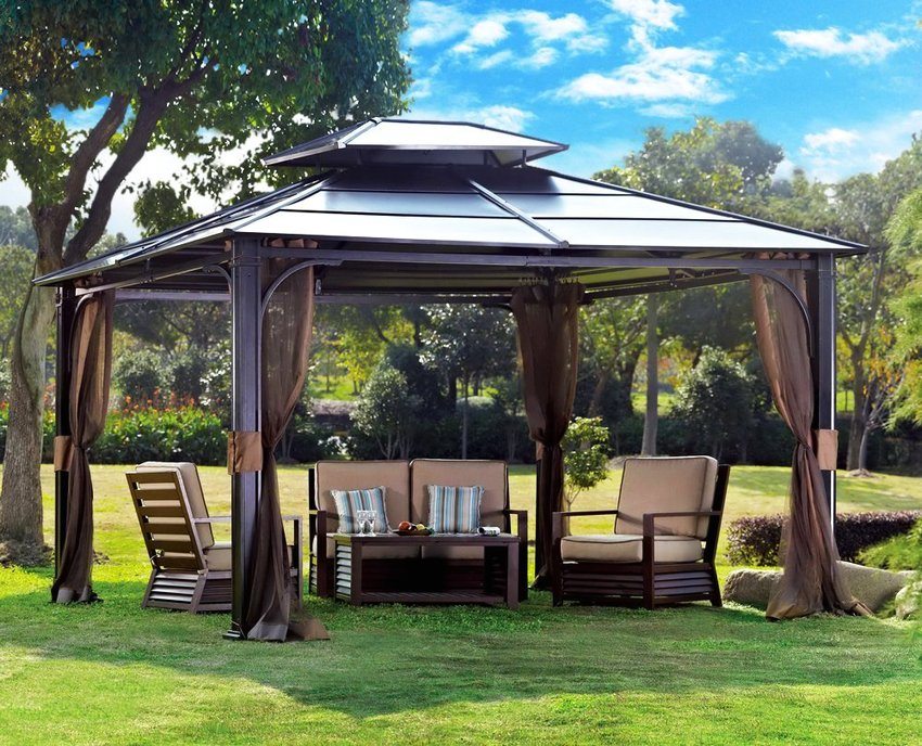 A canopy with a metal frame, installed in the courtyard of a country house
