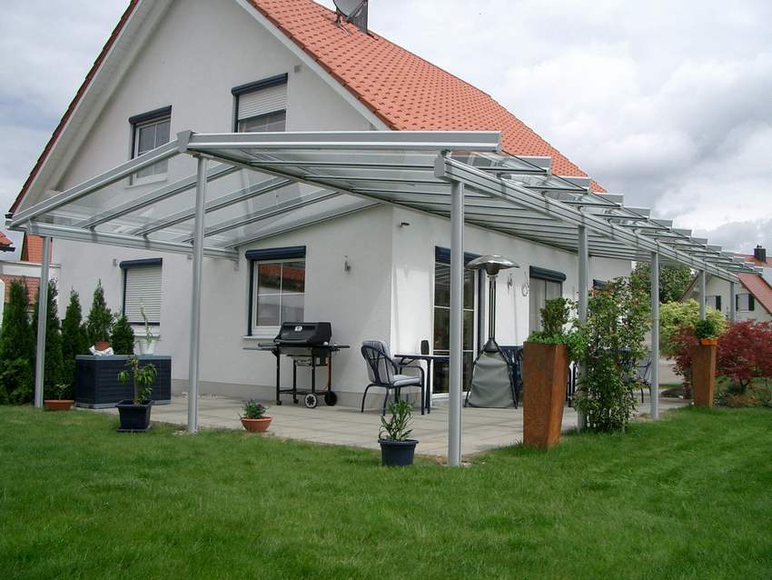 Polycarbonate canopy attached to the wall of the house