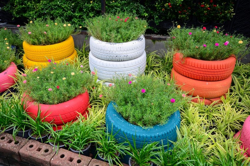 Bright flower beds of different heights, made of car tires