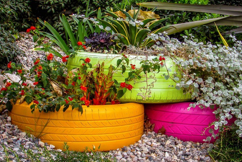 Bright flower bed of tires in the courtyard of a country house
