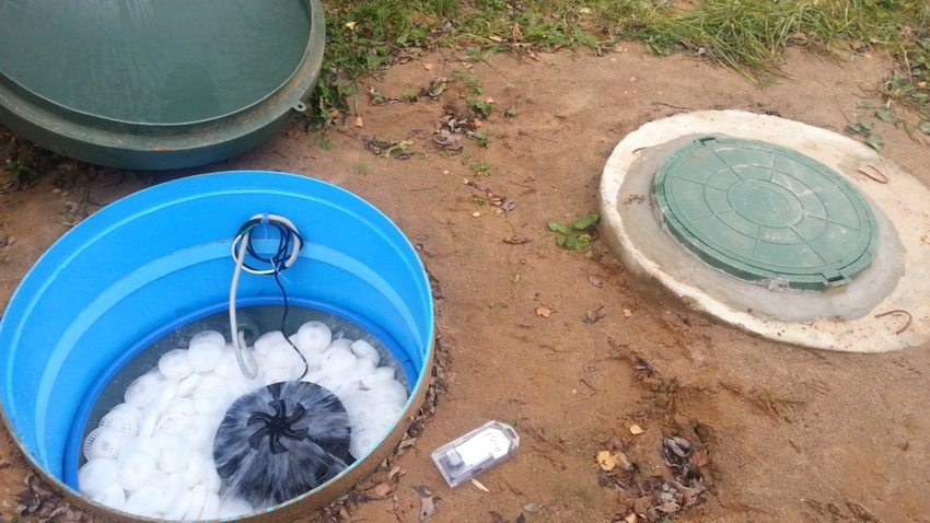 Homemade biological filter from a barrel and washcloths; air compressor aerates waste water to activate aerobic bacteria