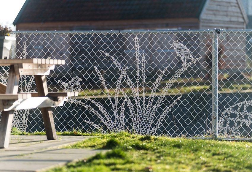 Chain-link fence decorated with embroidery