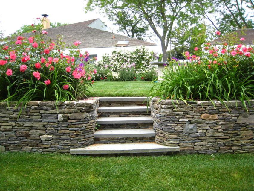 Two stone flower beds frame the garden steps
