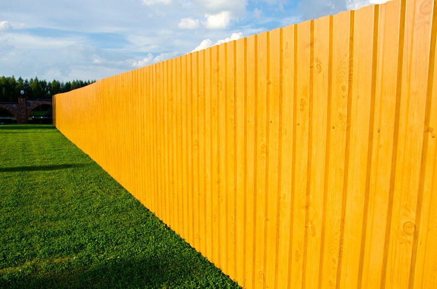 Fence made of profiled sheets with imitation of wood