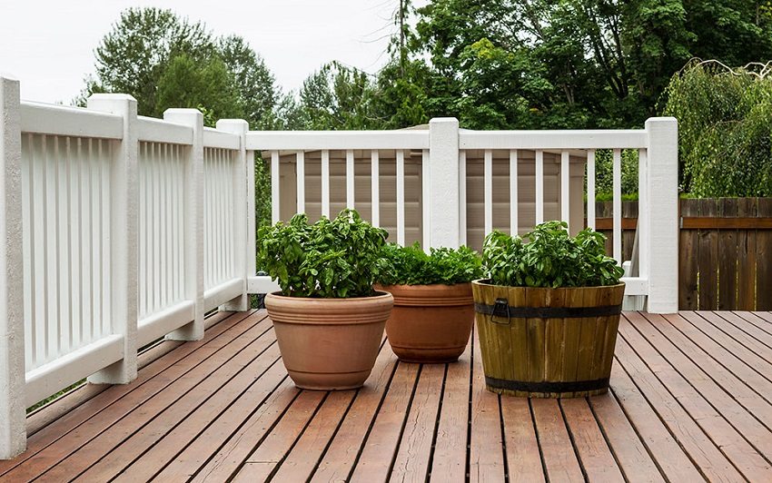Wooden fencing with thin slats in sections and solid posts