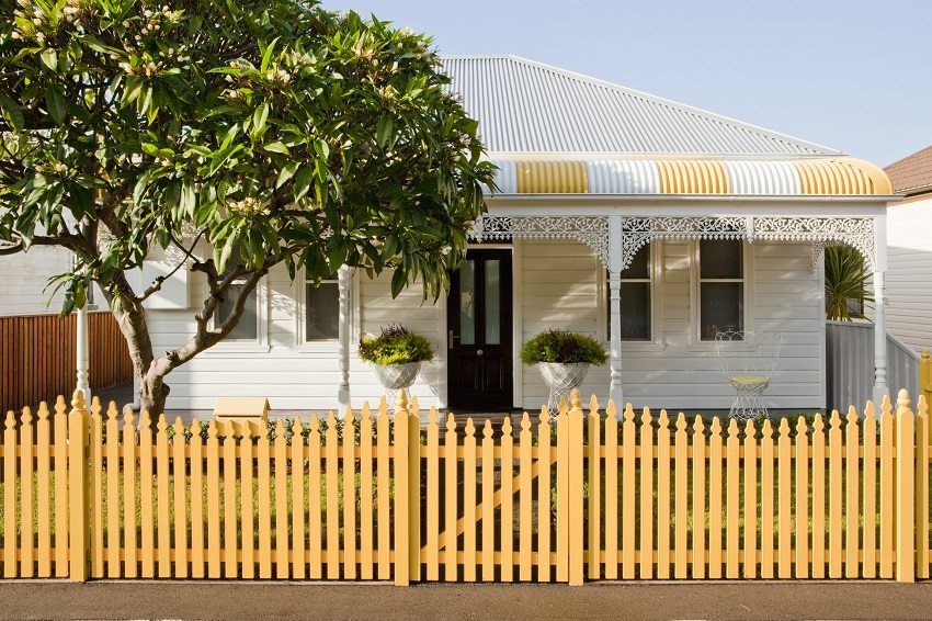 Wooden picket fence, painted yellow, is a source of cheerful mood