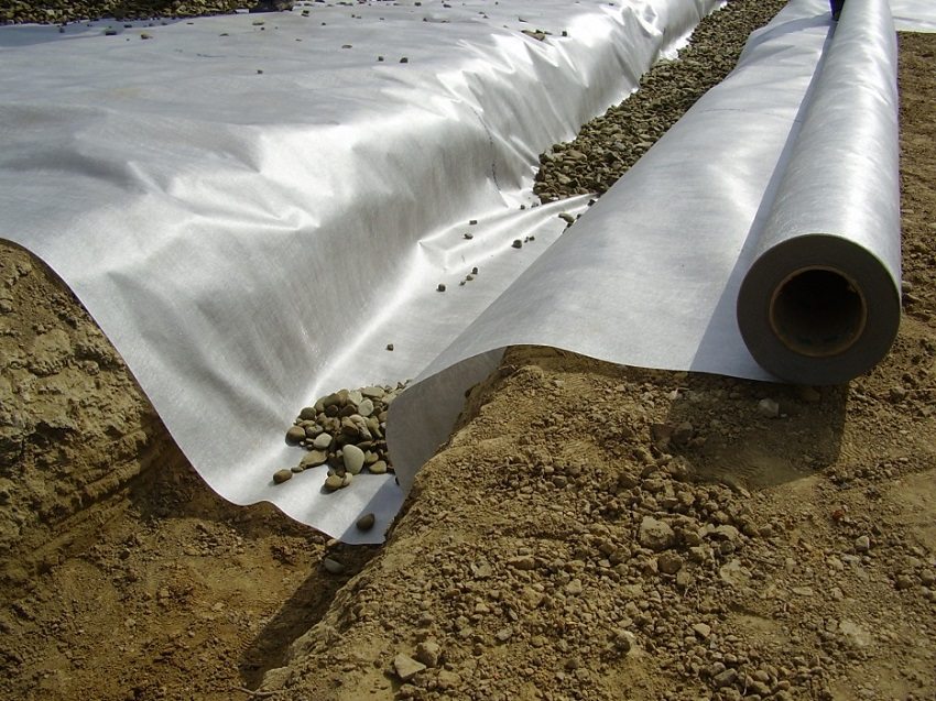 Crushed stone wrapped in geotextile is used as drainage