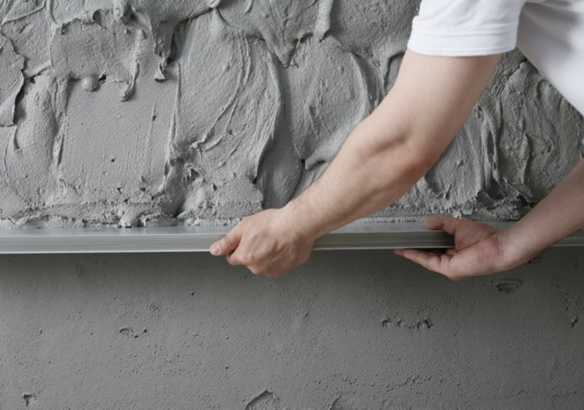 Brick and concrete walls must first be leveled with rough plaster