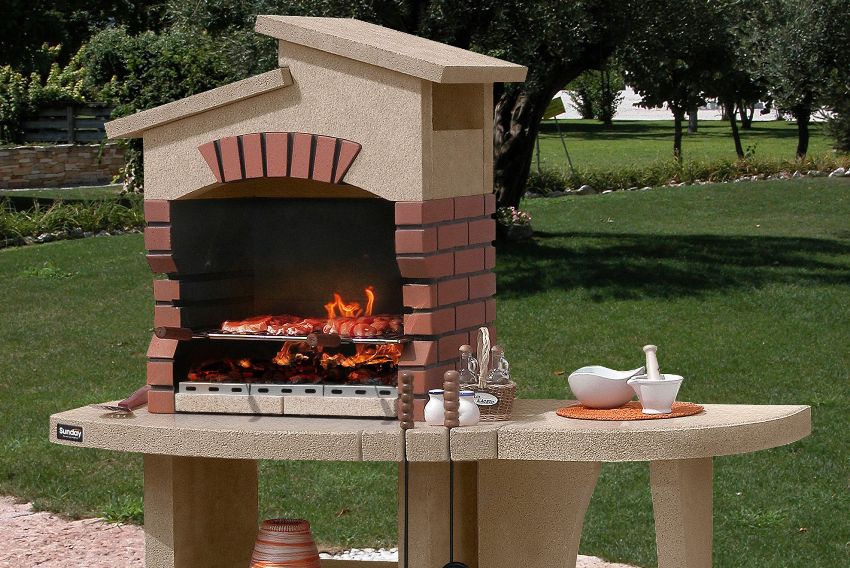 Convenient brick grill with a roof and an additional table