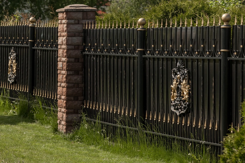 Kovana ograda s valovitom pločom omogućuje vam zatvaranje područja od znatiželjnih očiju, zadržavajući pritom izgled ograde