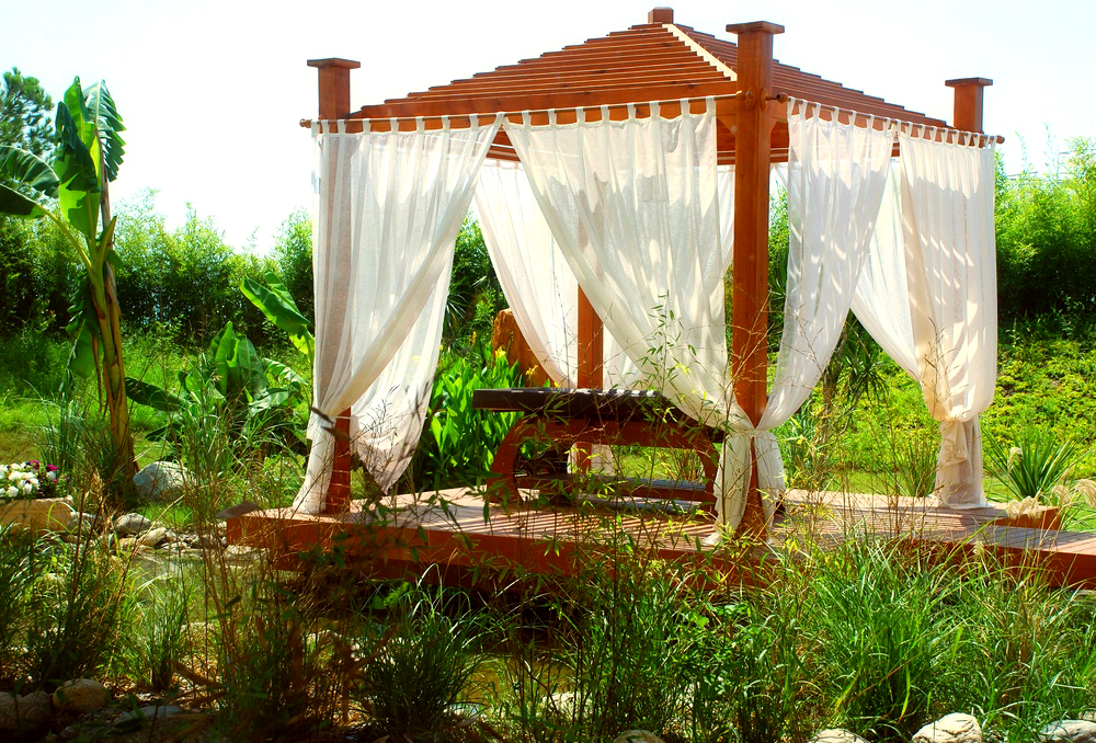 To make the pergola gazebo more comfortable, it can be decorated with light curtains