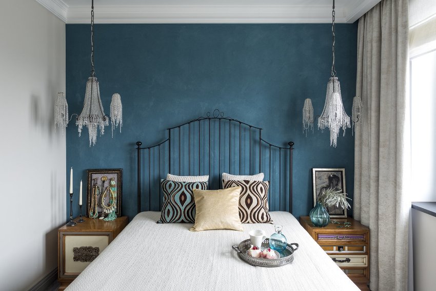 Akcentni zid na vrhu kreveta s bojom izvrstan je trik za dizajn za isticanje središnjeg komada namještaja u maloj spavaćoj sobi