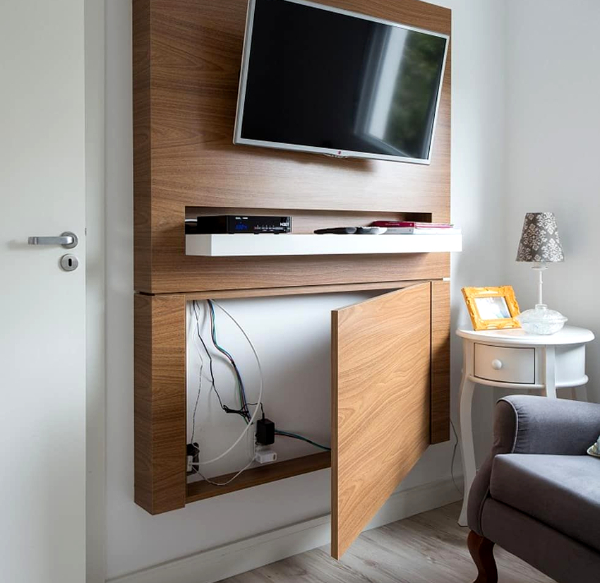 Decorative panels made of wood or plastic help hide the wires from the TV mounted on the wall