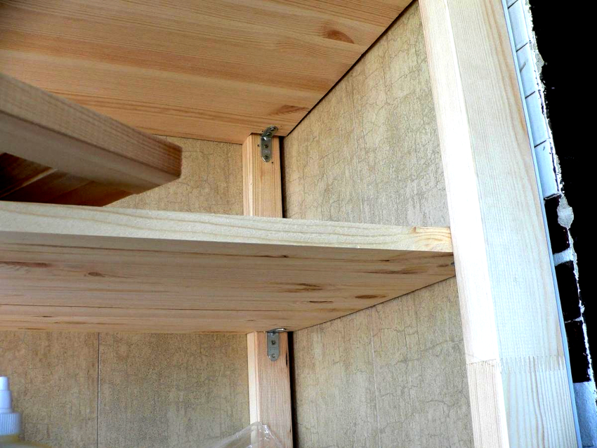 Walls and shelves of the cabinet on the balcony, fastened together using furniture corners