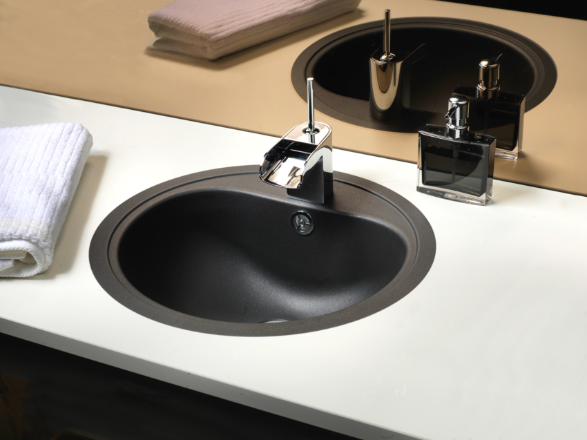 The Reginox Atlantis metal built-in sink has a round shape and a matte surface