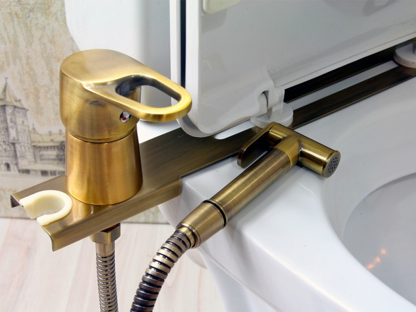 The set for the bidet attachment includes hoses, a mixer, a metal panel and a shower head