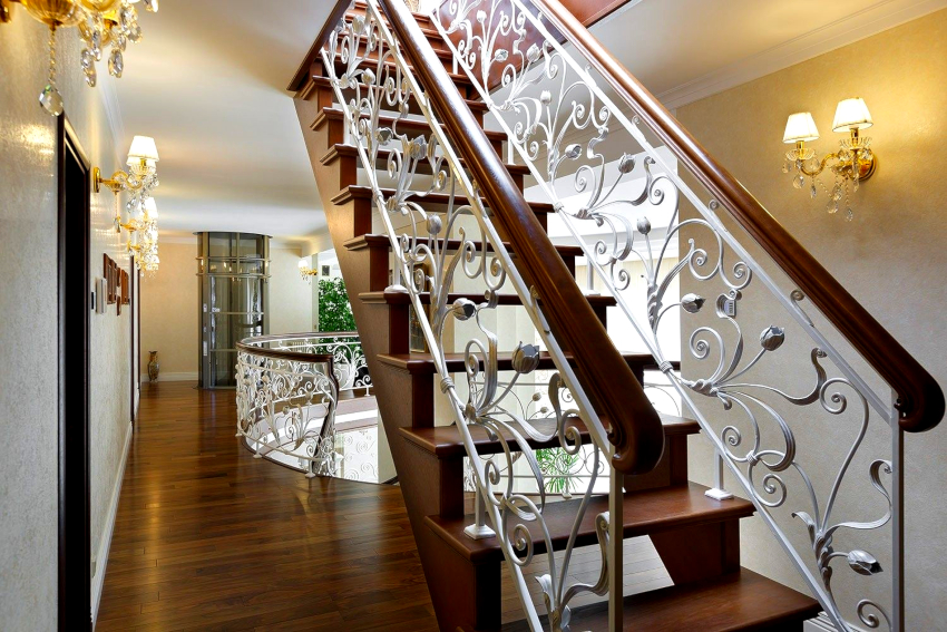 Wrought iron railings with wooden handrails are the most demanded stair railing
