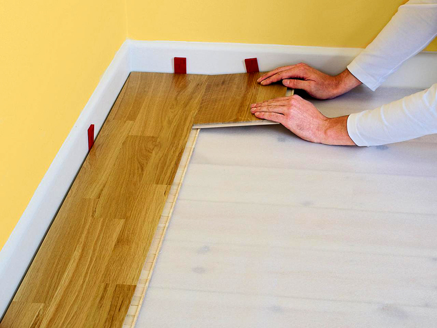 Wedges provide the required gap between the wall and the laminate
