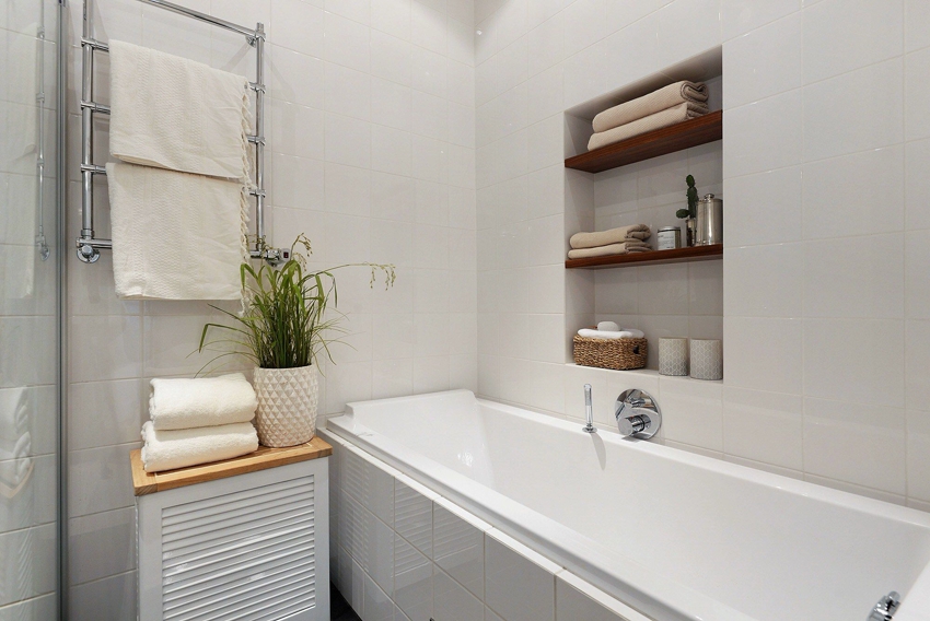 Built-in shelves save space in the bathroom, yet they are very practical